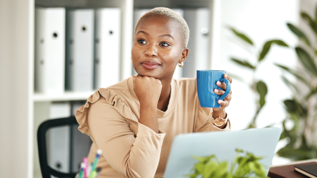 TC vs. REVA vs. Listing Coordinator: How to Choose the Right Role in Real Estate 1 woman in front of a laptop drinking from a mug and in a thinking position