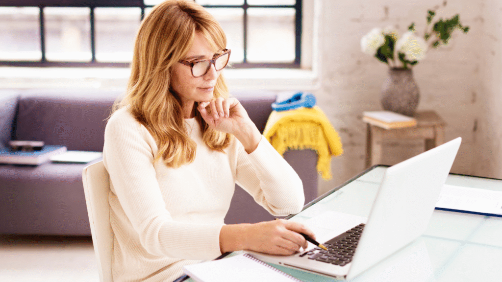 Per File vs. Retainer Pricing: What No One Tells New Transaction Coordinators 1 Professional transaction coordinator reviewing pricing and client workload on a laptop in a home office