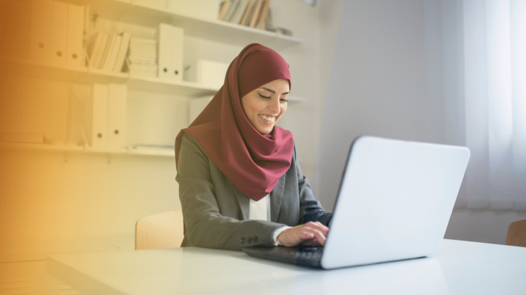 How to Explain Your Value to Price-Shopping Agents 1 Professional woman smiling while working on laptop